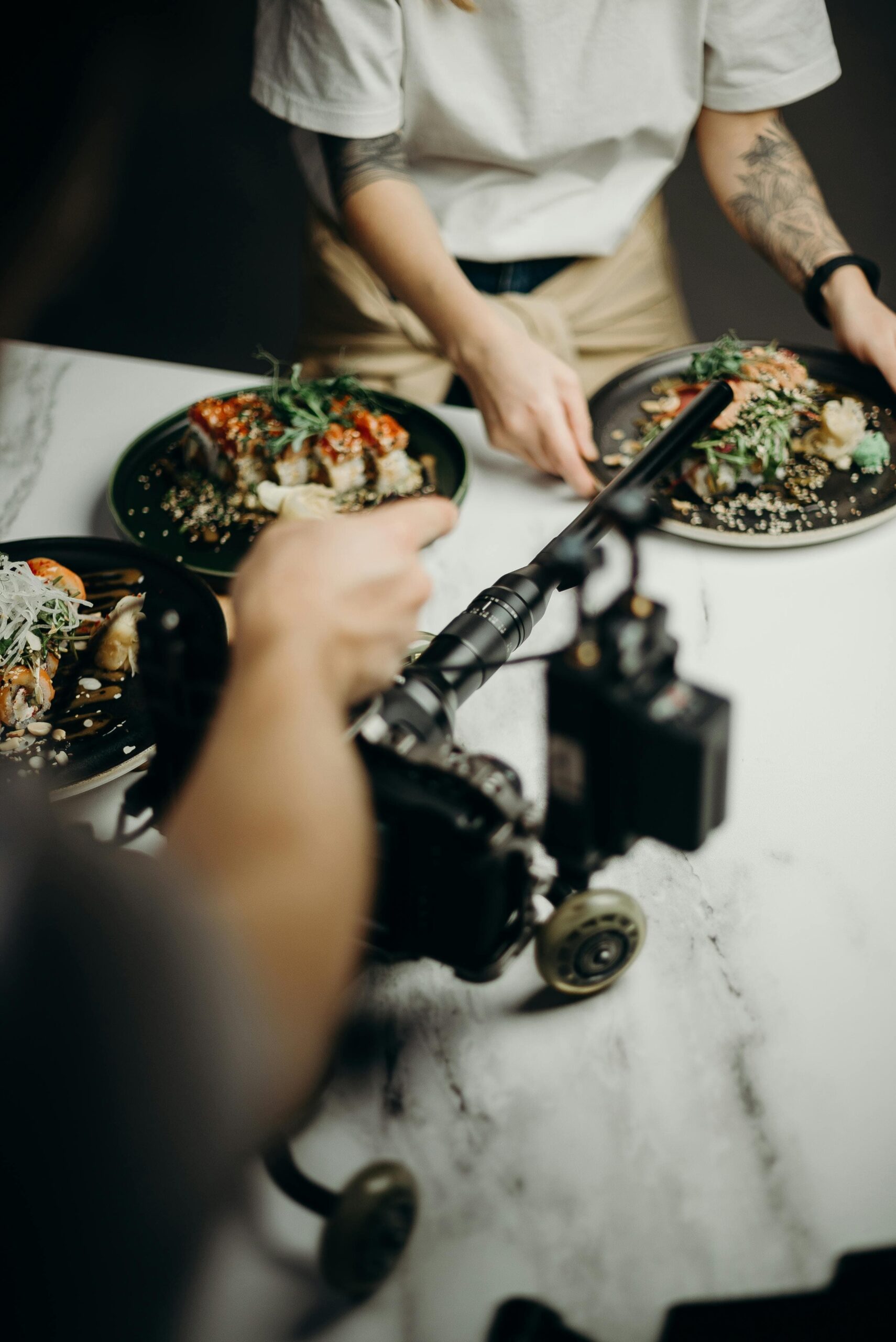 Individual filming chef preparing meal for marketing