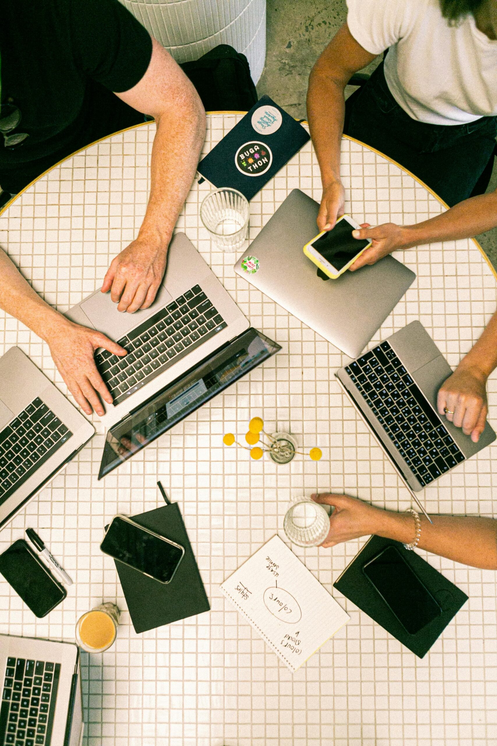 Multiple people working at computers together