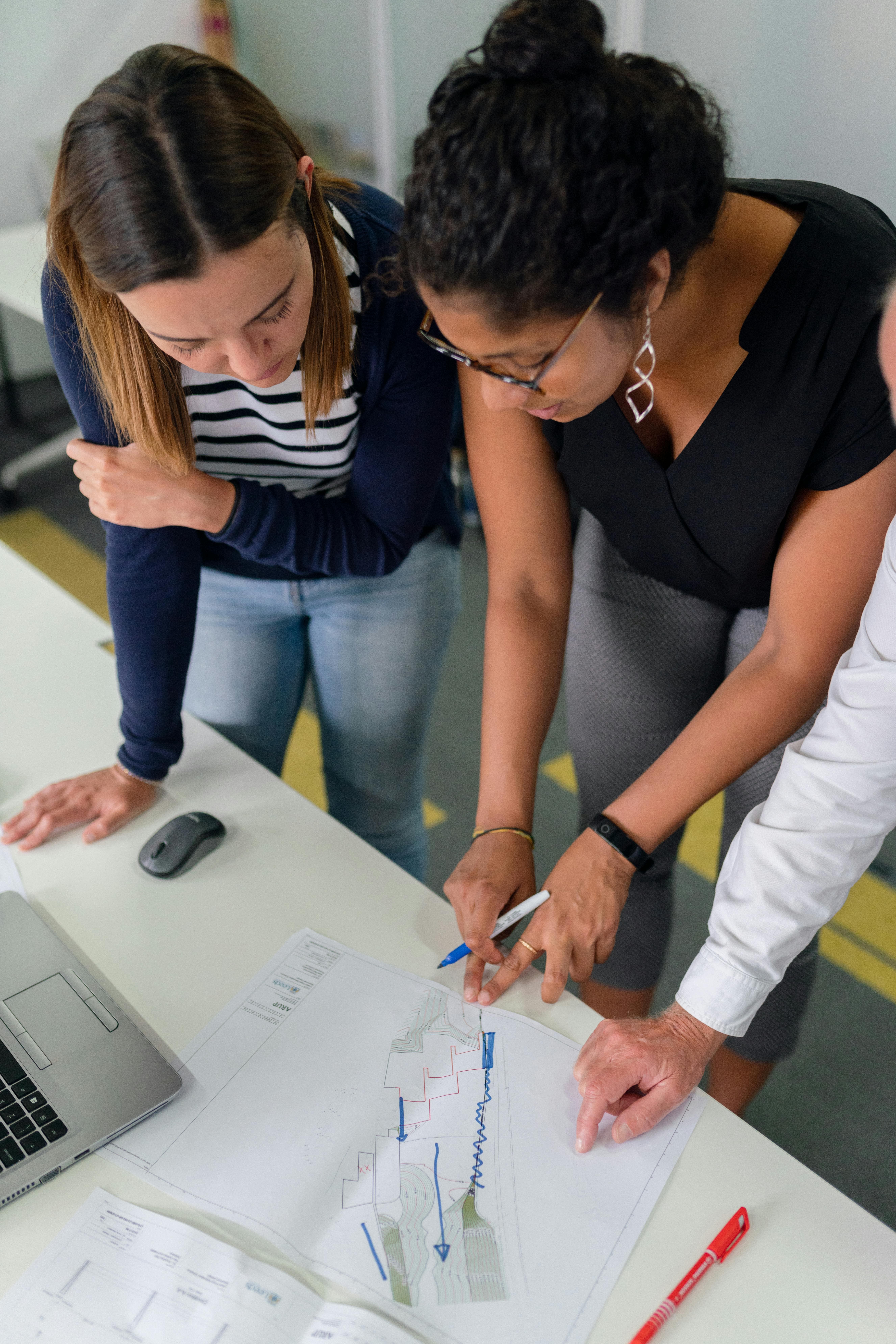 Two people looking at neighborhood map to plan franchise